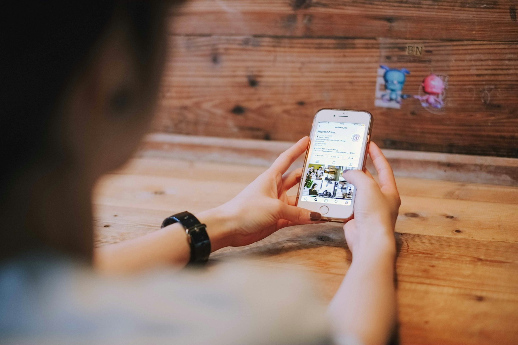 A smartphone displaying a grid of social media photos